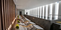 Elegant modern spa lounge with poolside windows, perfect for relaxation during your destination wedding at Majestic Mirage Costa Mujeres.