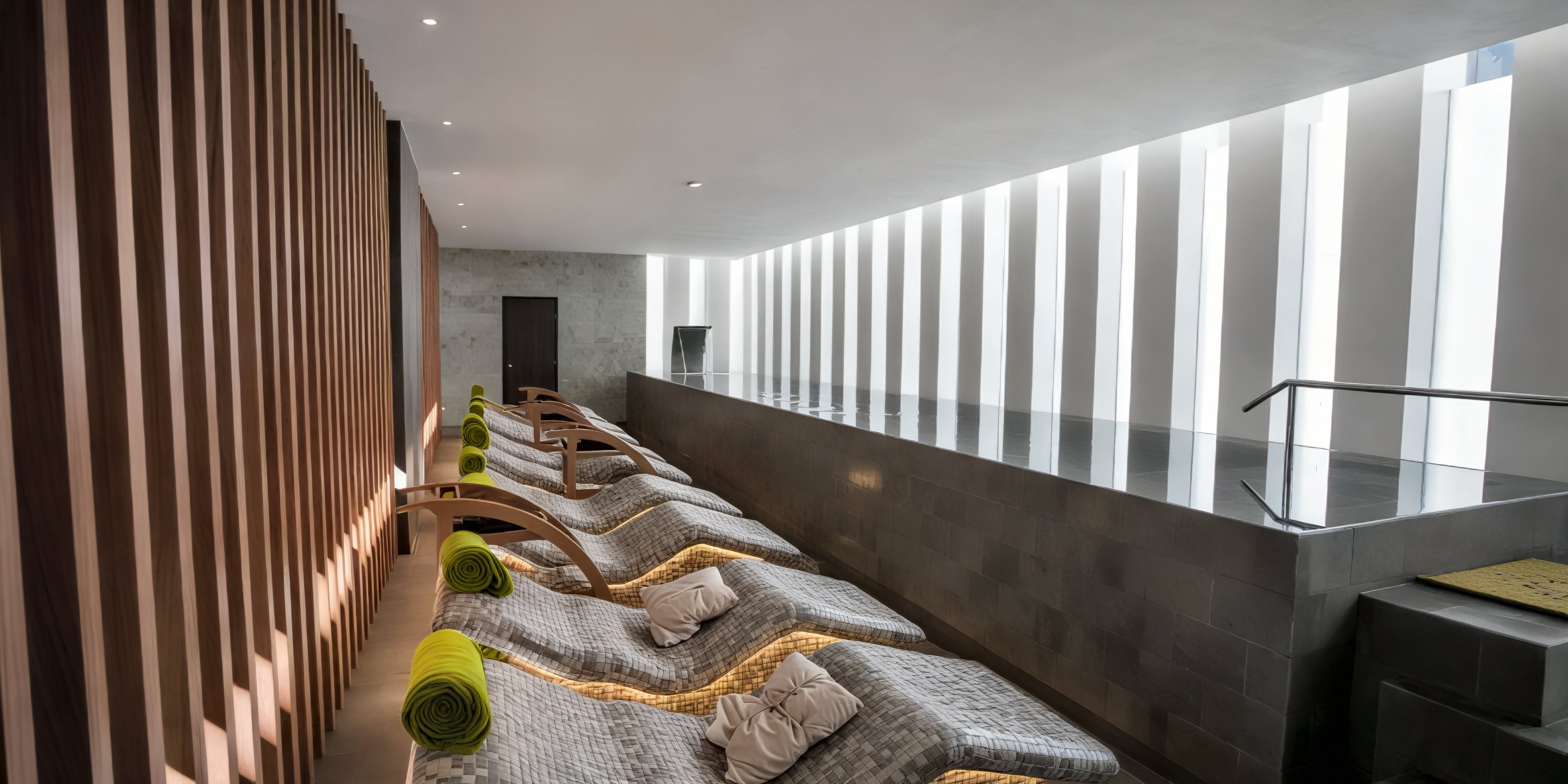 Elegant modern spa lounge with poolside windows, perfect for relaxation during your destination wedding at Majestic Mirage Costa Mujeres.