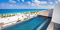 Infinity pool at Majestic Mirage Costa Mujeres, the perfect destination wedding backdrop, overlooking a white sand beach and stunning turquoise sea.