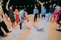 Aubrey and Noah: At their destination wedding, the bride is dipped low on the dance floor while guests cheer them on beneath the night sky.