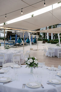 Kelsie and Matthew’s destination wedding featured elegant outdoor dining, with round tables adorned in white linens and beautiful floral centerpieces.
