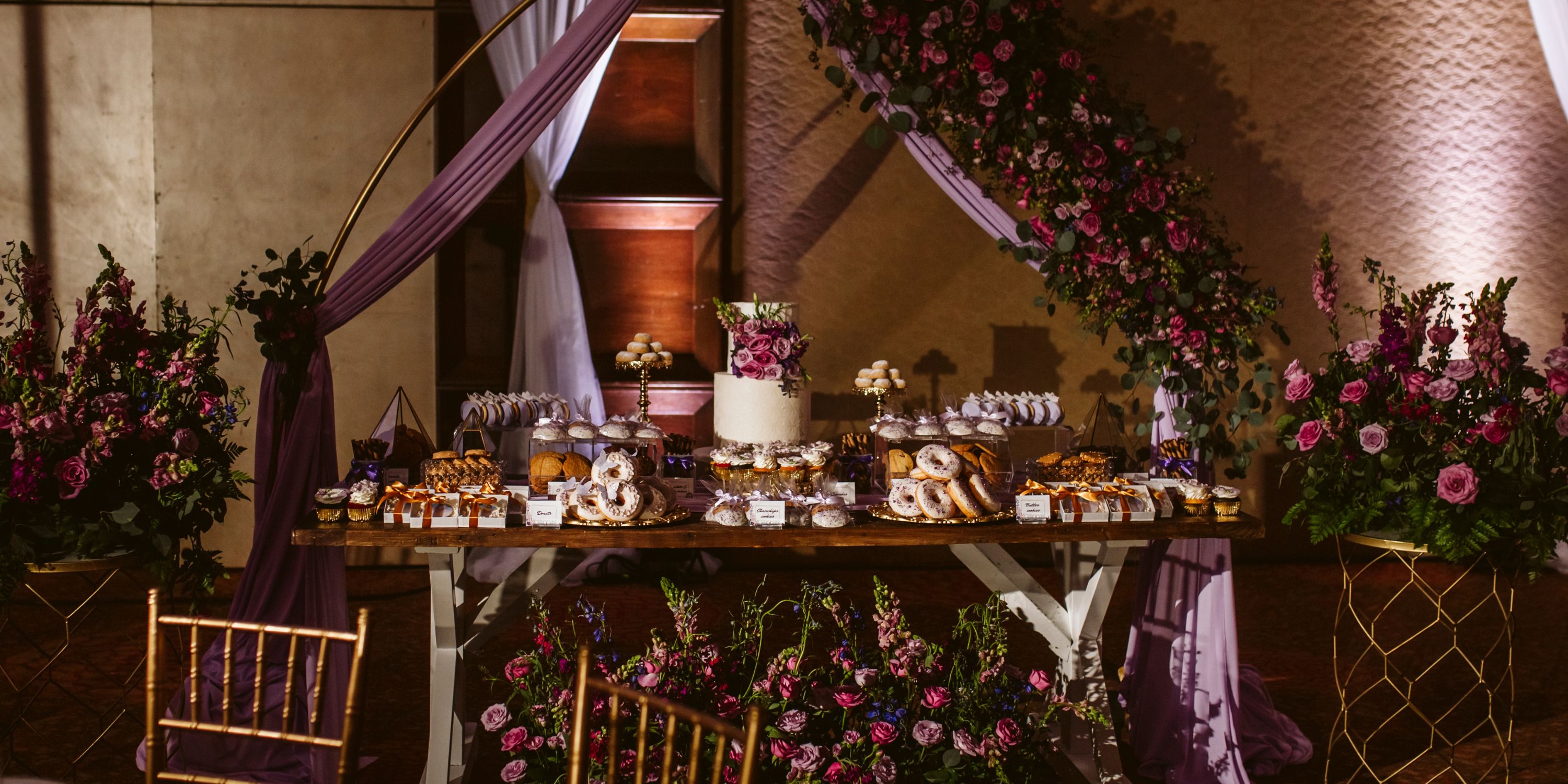 Elegant dessert table at a destination wedding in Moon Palace Nizuc with cake, pastries, and floral d&eacute;cor.