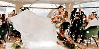A bride and groom share a kiss on the dance floor during their destination wedding at Moon Palace Nizuc, surrounded by guests.