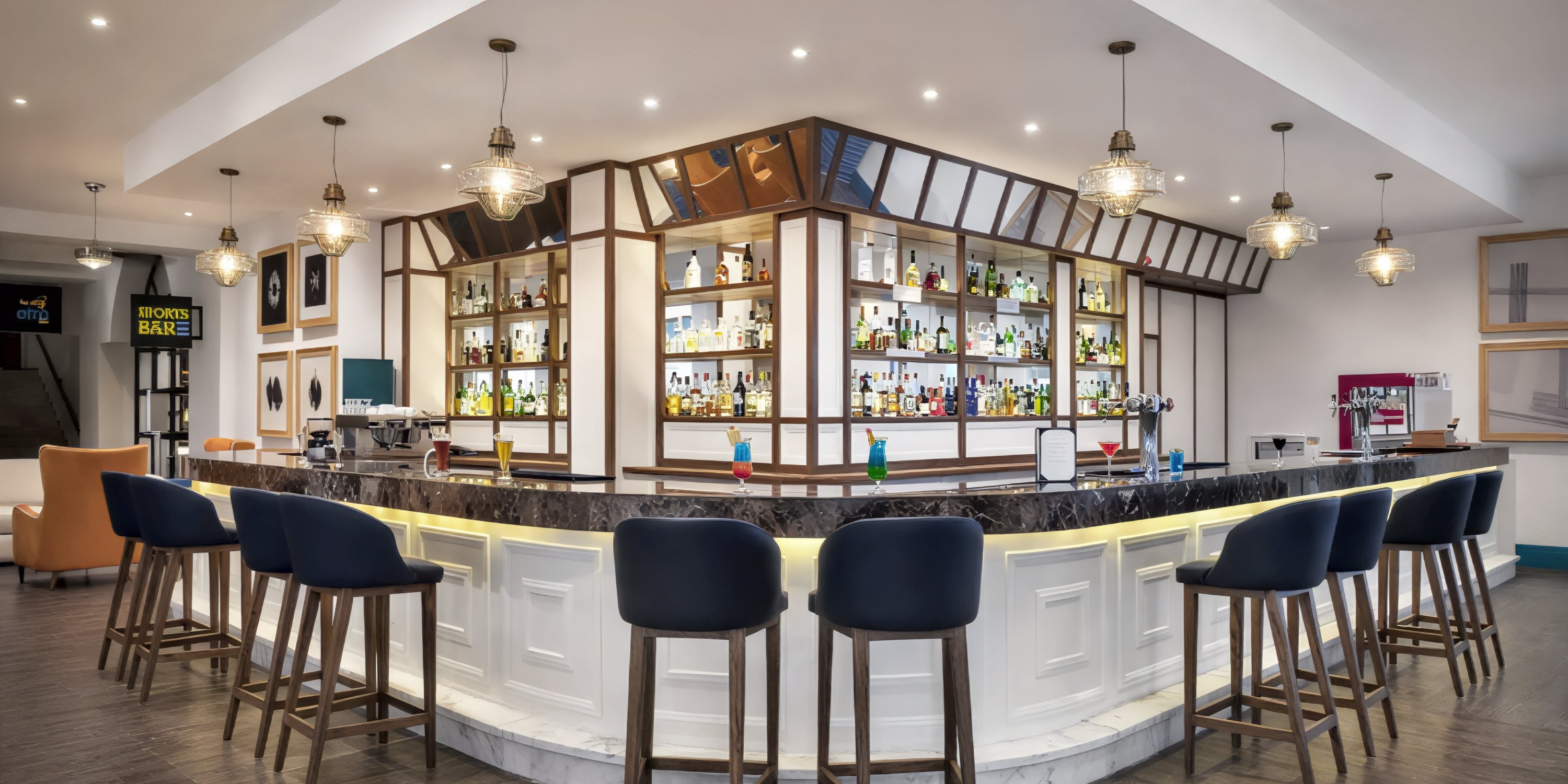 A stylish bar at Ocean Coral and Turquesa hotel, featuring blue chairs, a marble counter, and fully stocked shelves—an ideal spot for guests to unwind during a destination wedding celebration.