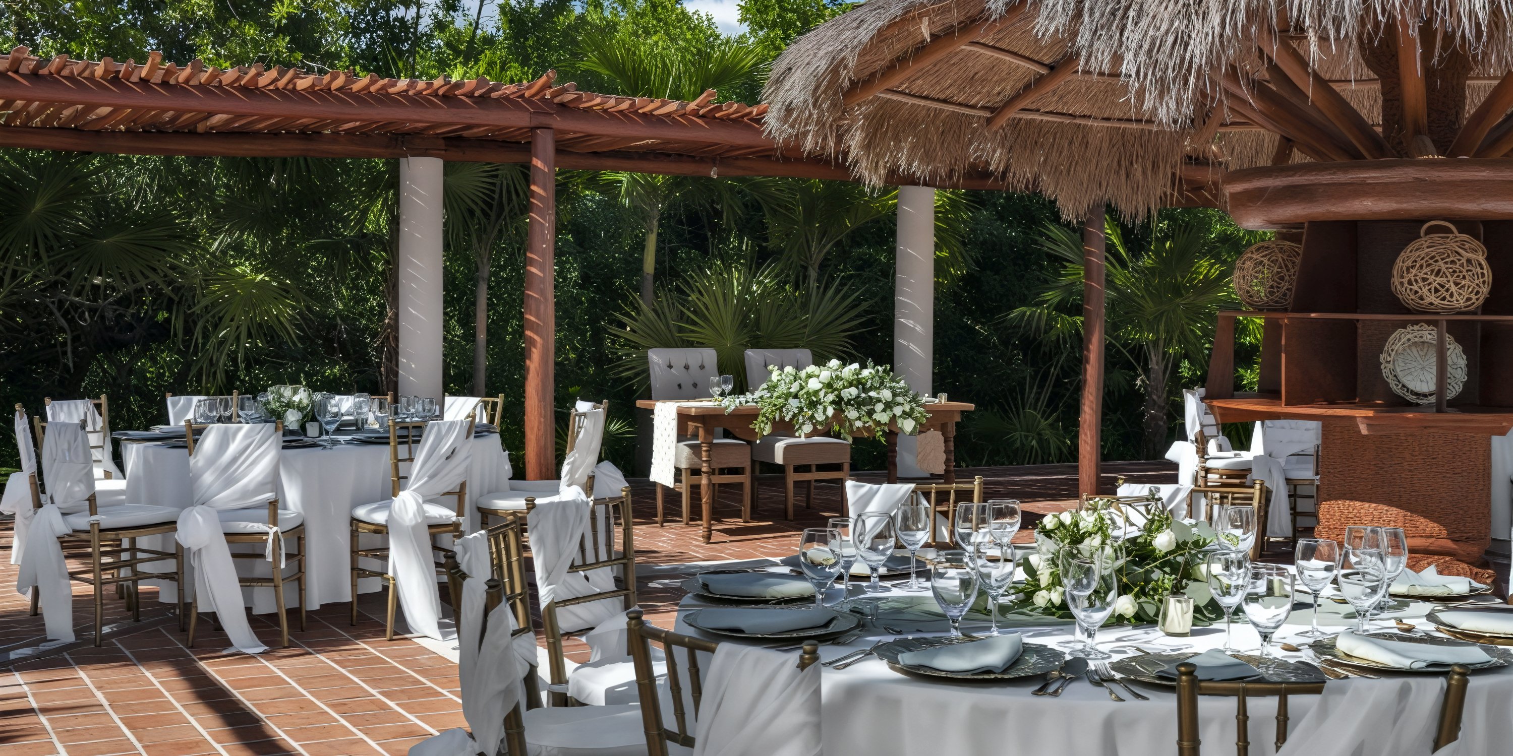 Ocean Maya Royale destination wedding setup features round tables adorned with elegant white linens and stunning floral centerpieces, creating a beautiful outdoor wedding atmosphere.