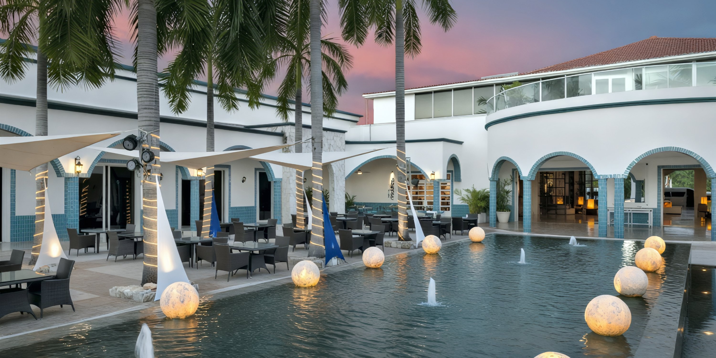 Ocean Coral and Turquesa: an idyllic destination wedding venue featuring poolside dining surrounded by swaying palm trees, elegant white awnings, and romantic sunset lighting.