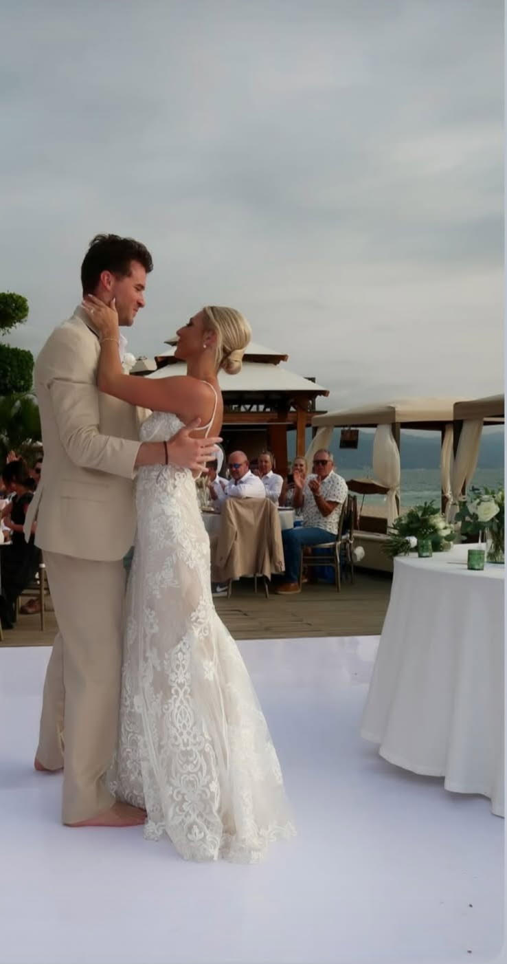 Leah and Christopher enjoy their first dance together at their outdoor destination wedding reception.