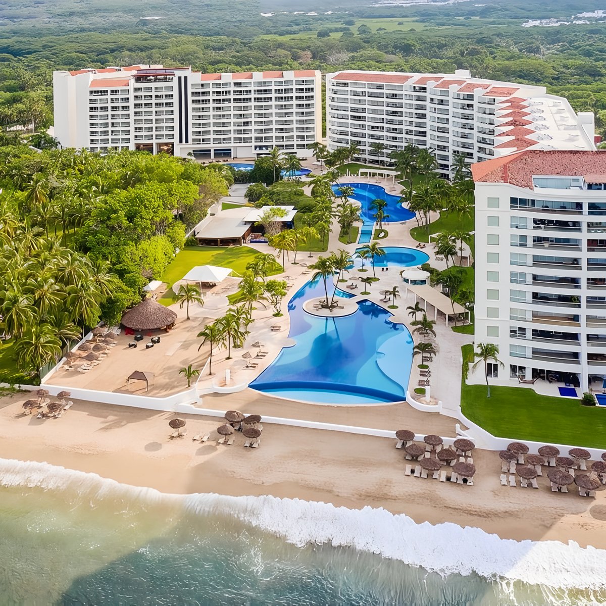 Aerial view of Fiesta Americana Nuevo Vallarta resort, showcasing its stunning pools, lush palm trees, and breathtaking ocean views—an ideal setting for a memorable destination wedding.