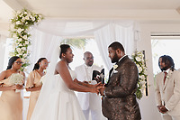 Jordan and Kievan exchange vows at their destination wedding, joined by their officiant and wedding party.