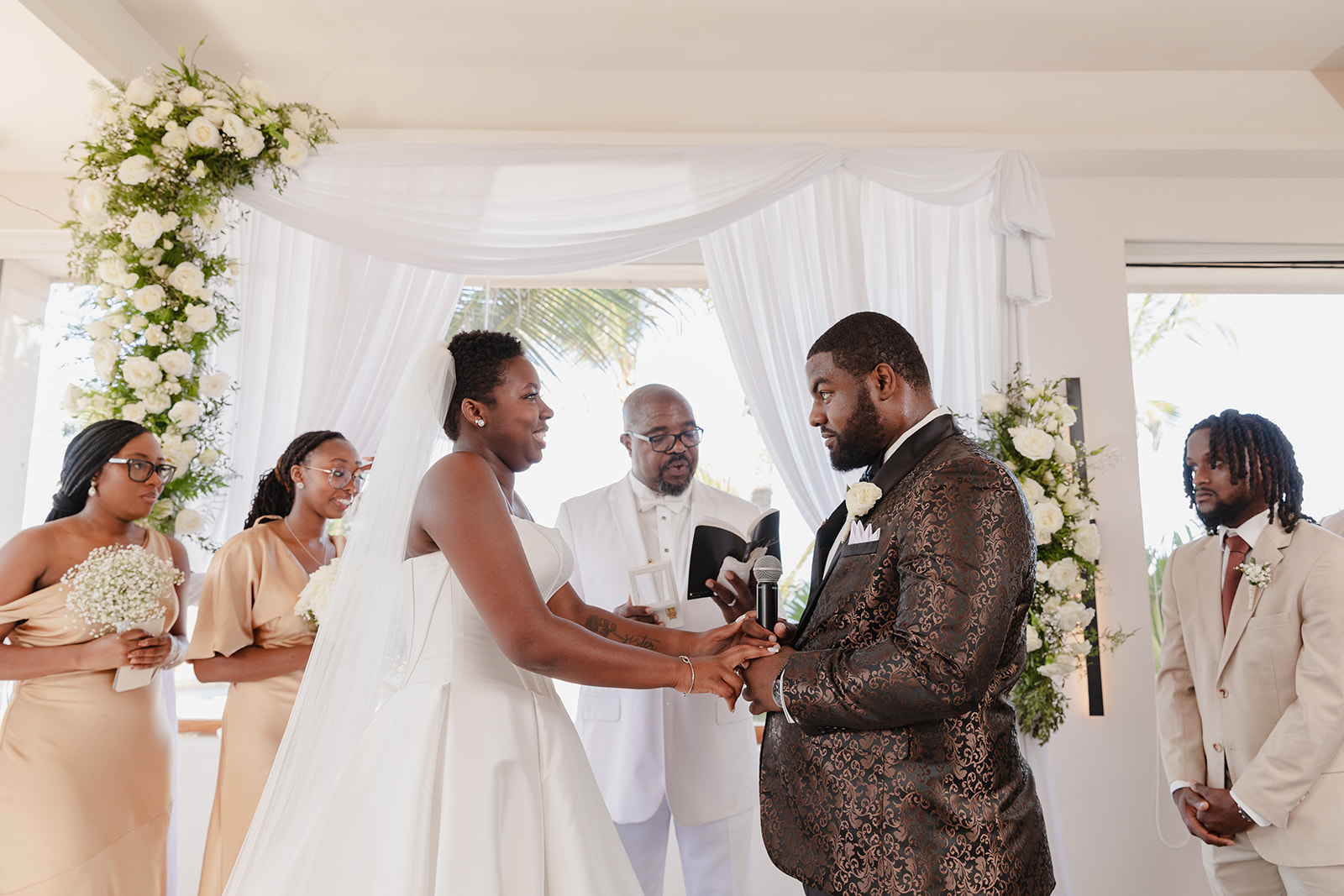 Jordan and Kievan exchange vows at their destination wedding, joined by their officiant and wedding party.