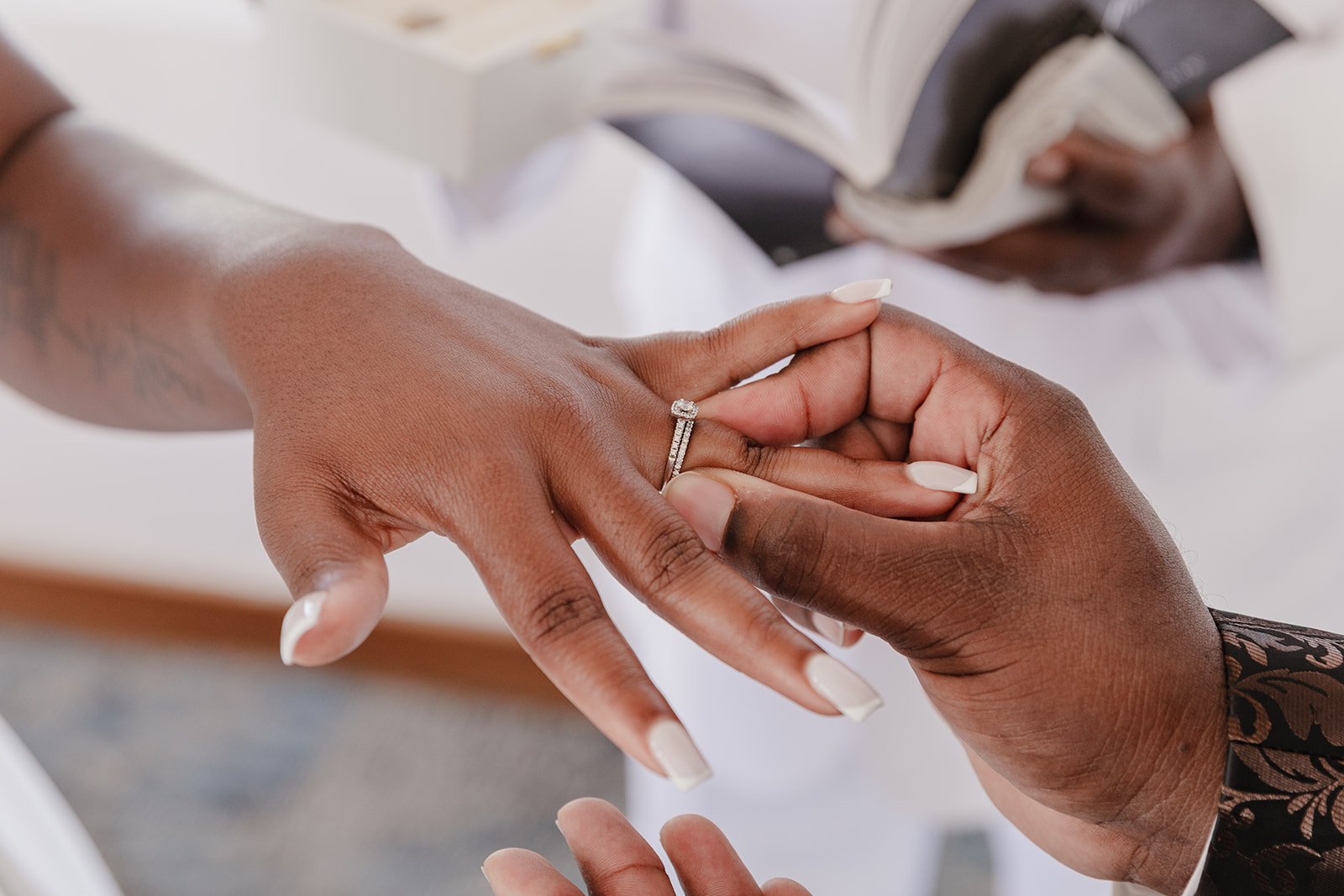At the destination wedding ceremony, a Jordan and Kievan ring is placed on someone's finger.