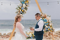 Teneal and Jonathan exchange vows during a stunning outdoor beach destination wedding ceremony.