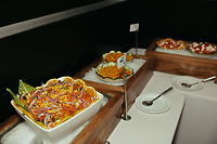 Stephanie and Mark’s destination wedding features a salad bar with bowls on ice and serving spoons.