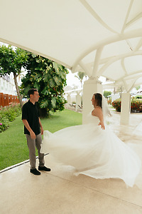 Stephanie and Mark celebrate at their destination wedding as the bride twirls in her dress outdoors.