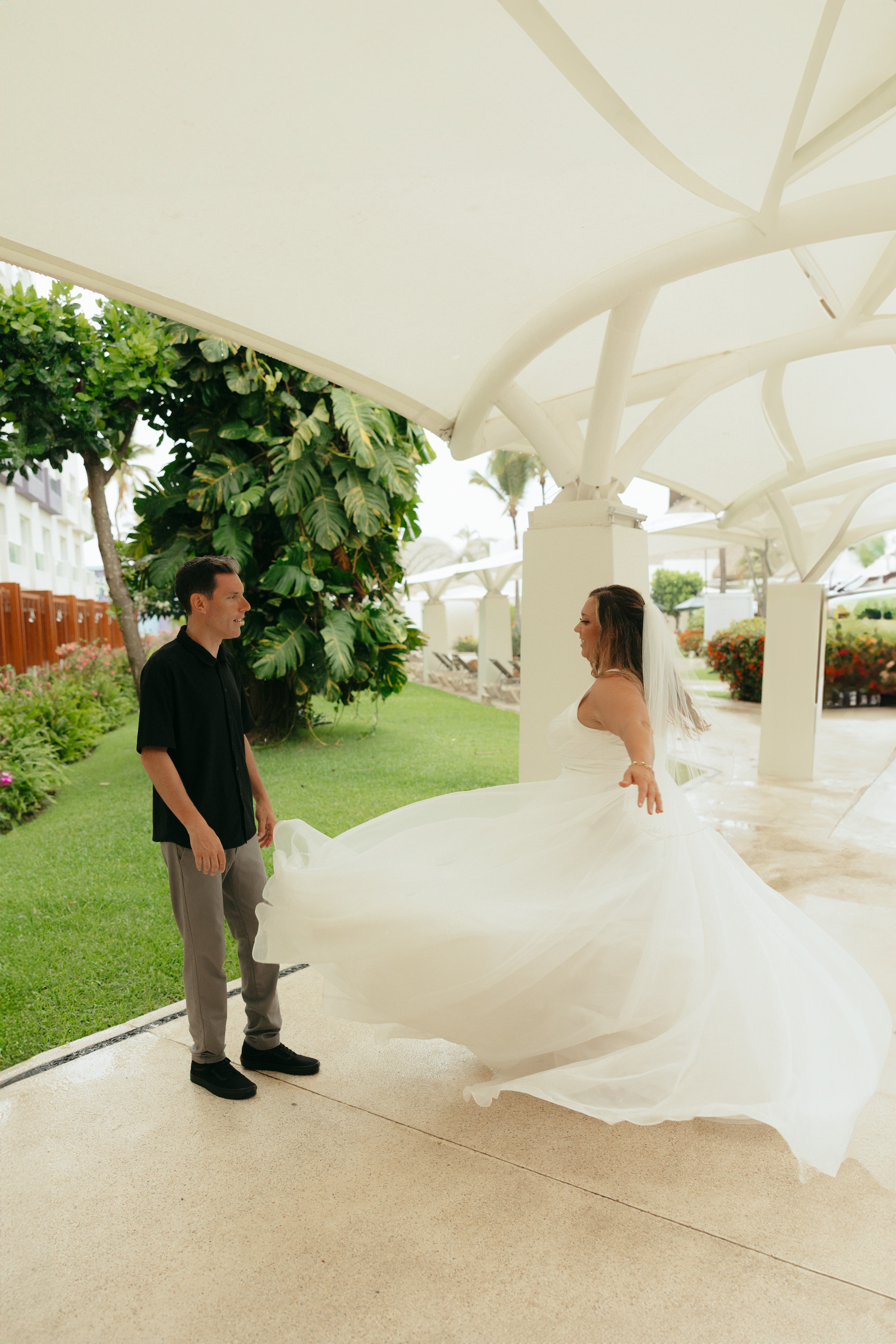Stephanie and Mark celebrate at their destination wedding as the bride twirls in her dress outdoors.