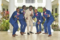Five men in suits—four in blue and one in tan—pose indoors for a photo at the destination wedding, captured as "Kiah and Rodney (Copy).