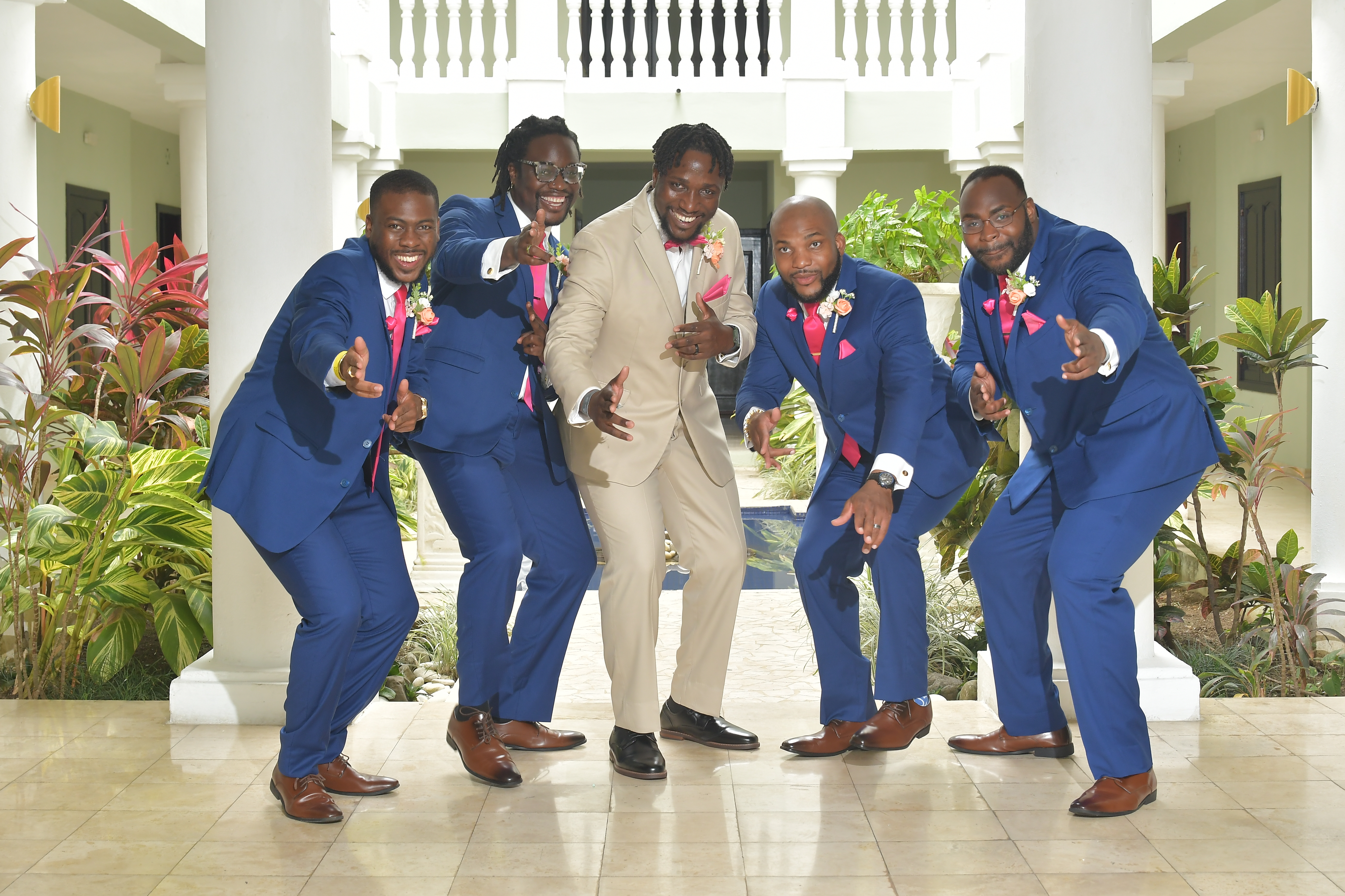 Five men in suits—four in blue and one in tan—pose indoors for a photo at the destination wedding, captured as "Kiah and Rodney (Copy).