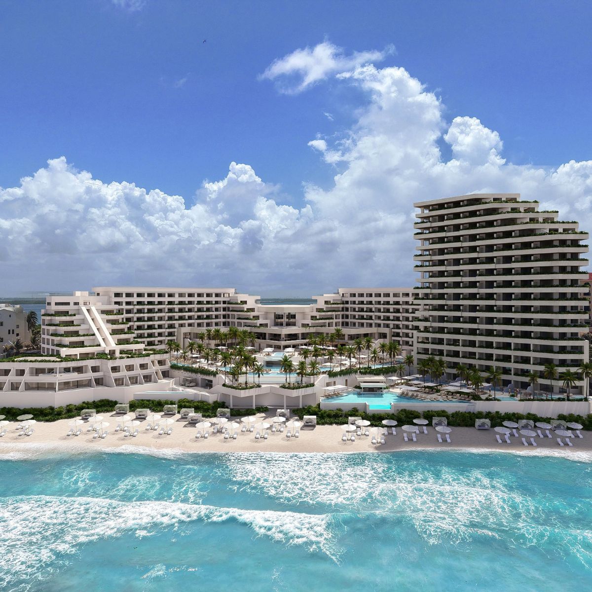 A modern beachfront resort ideal for destination weddings, with pools, palm trees, and ocean views.