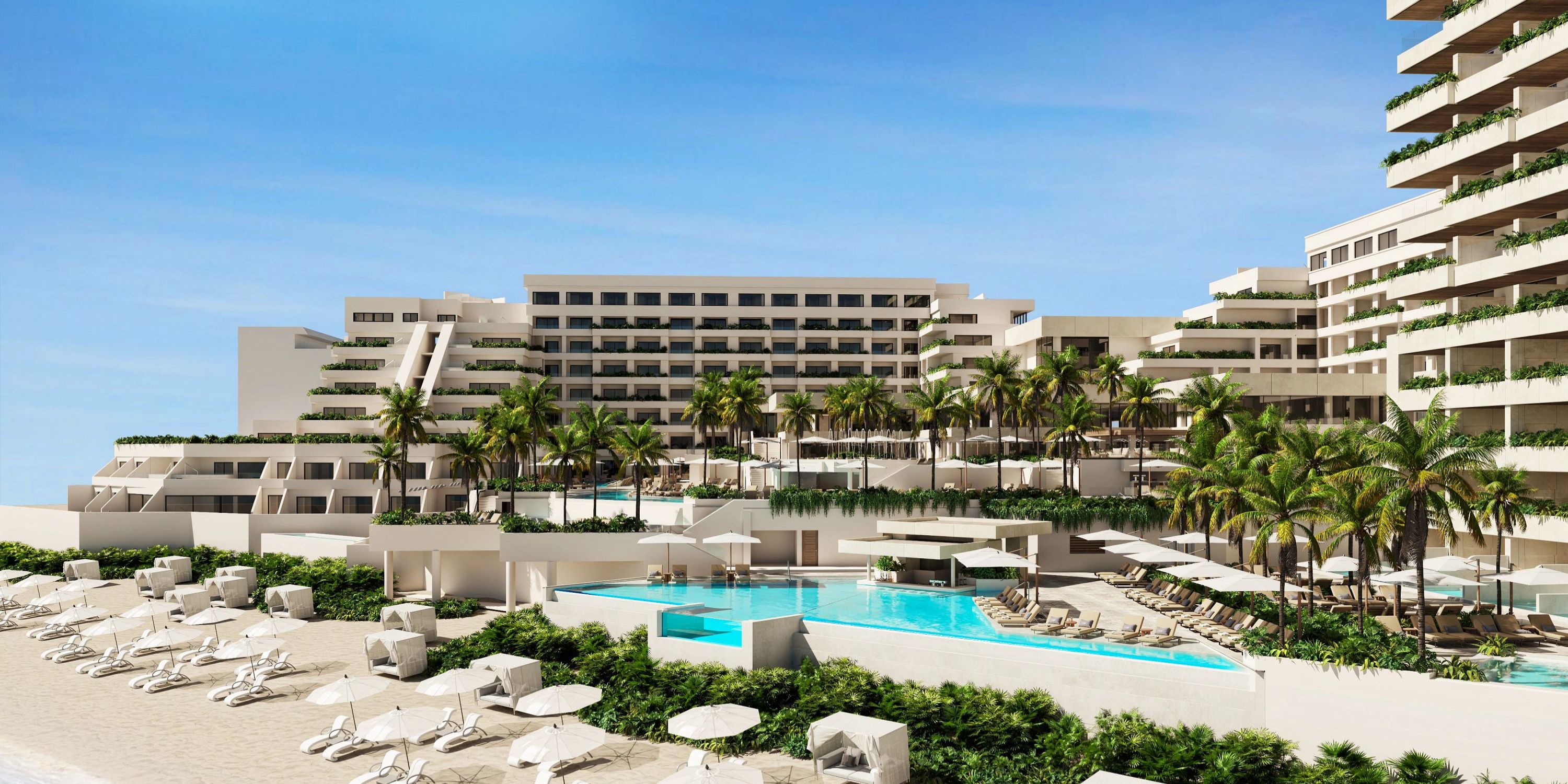 A large building perfect for a destination wedding, featuring a pool and umbrellas.