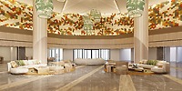 Elegant hotel lobby with round sofas, marble floors—ideal for a destination wedding; vibrant wall art.