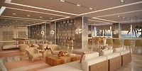 Modern hotel lounge ideal for a destination wedding, with neutral seating, marble pillars, and ocean views.