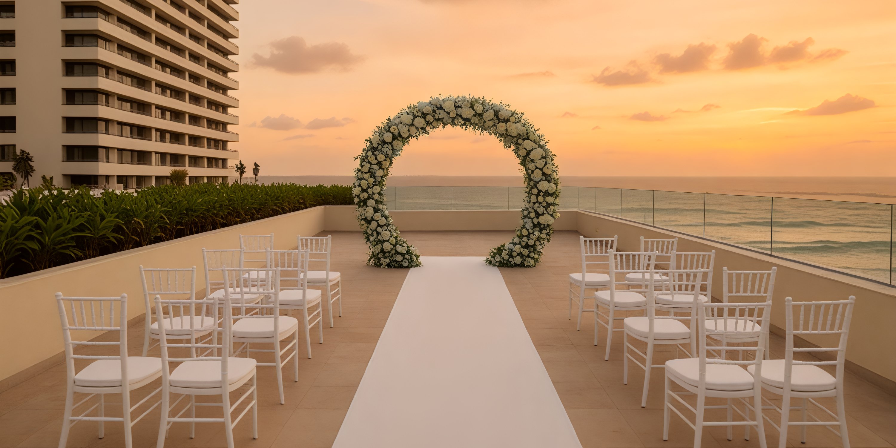 White chairs and a floral arch arranged for a destination wedding at Secrets Mirabel Cancun Resort & Spa.