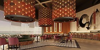 Chic restaurant interior ideal for a destination wedding, featuring pink chairs and bold lights by the bar.