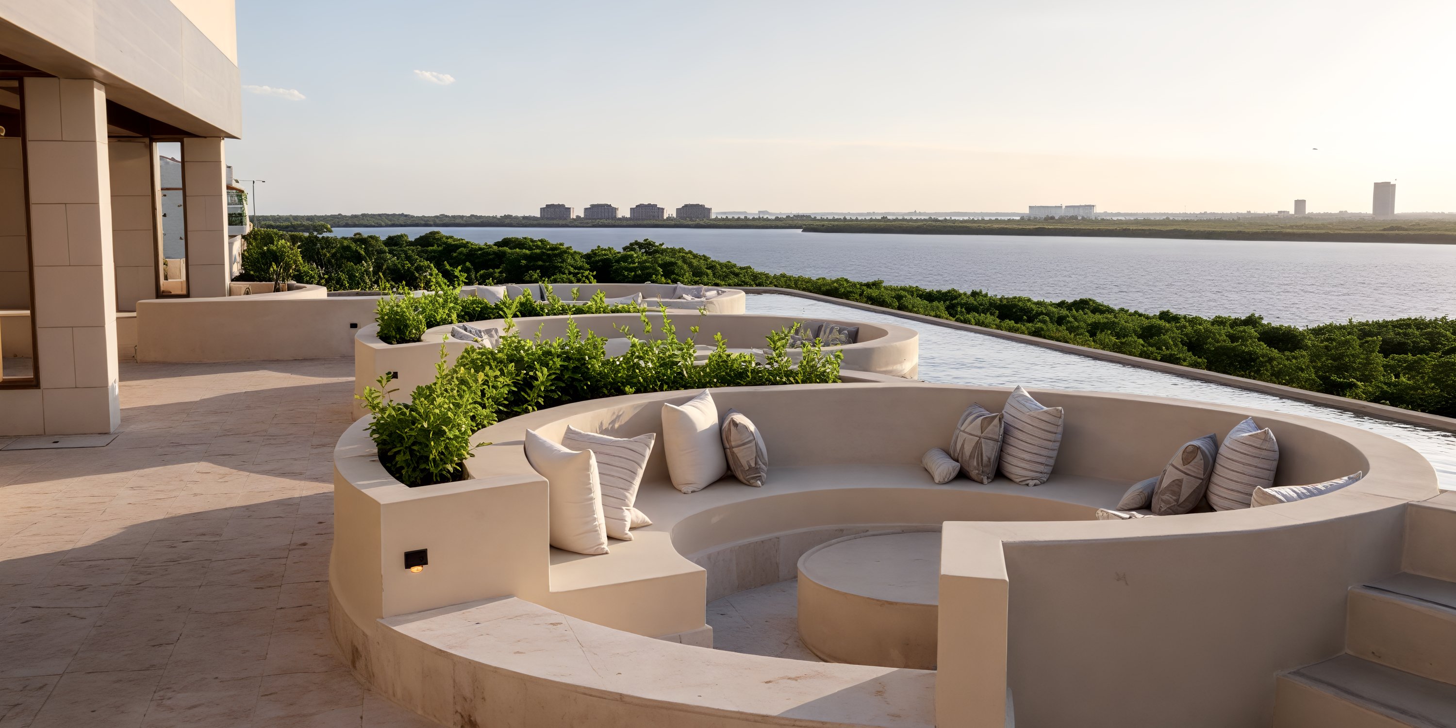 Curved outdoor seating with cushions overlooks water, perfect for a destination wedding at Secrets Mirabel Cancun.