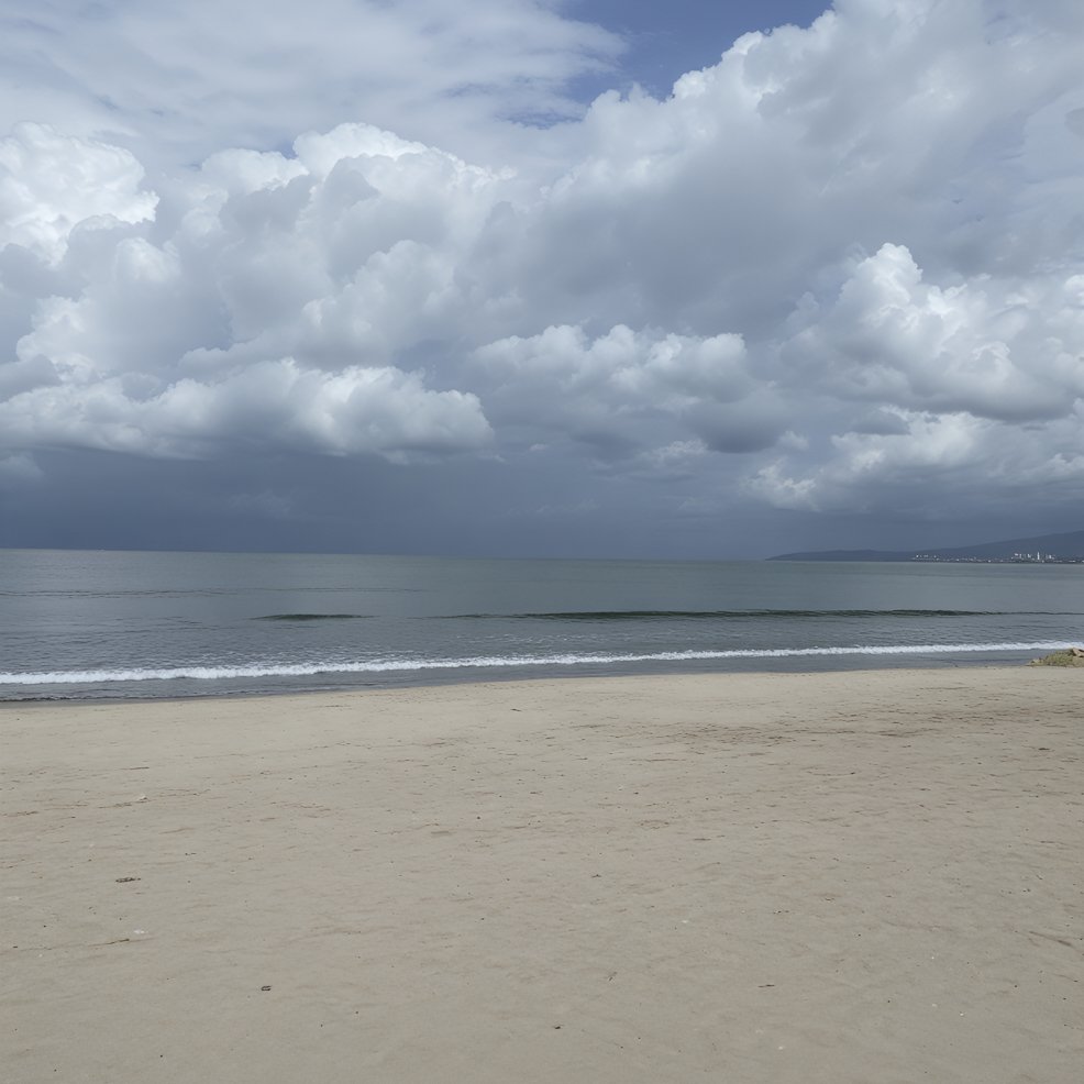 Cloudy sky over a calm ocean and empty sandy beach, perfect for a destination wedding backdrop.