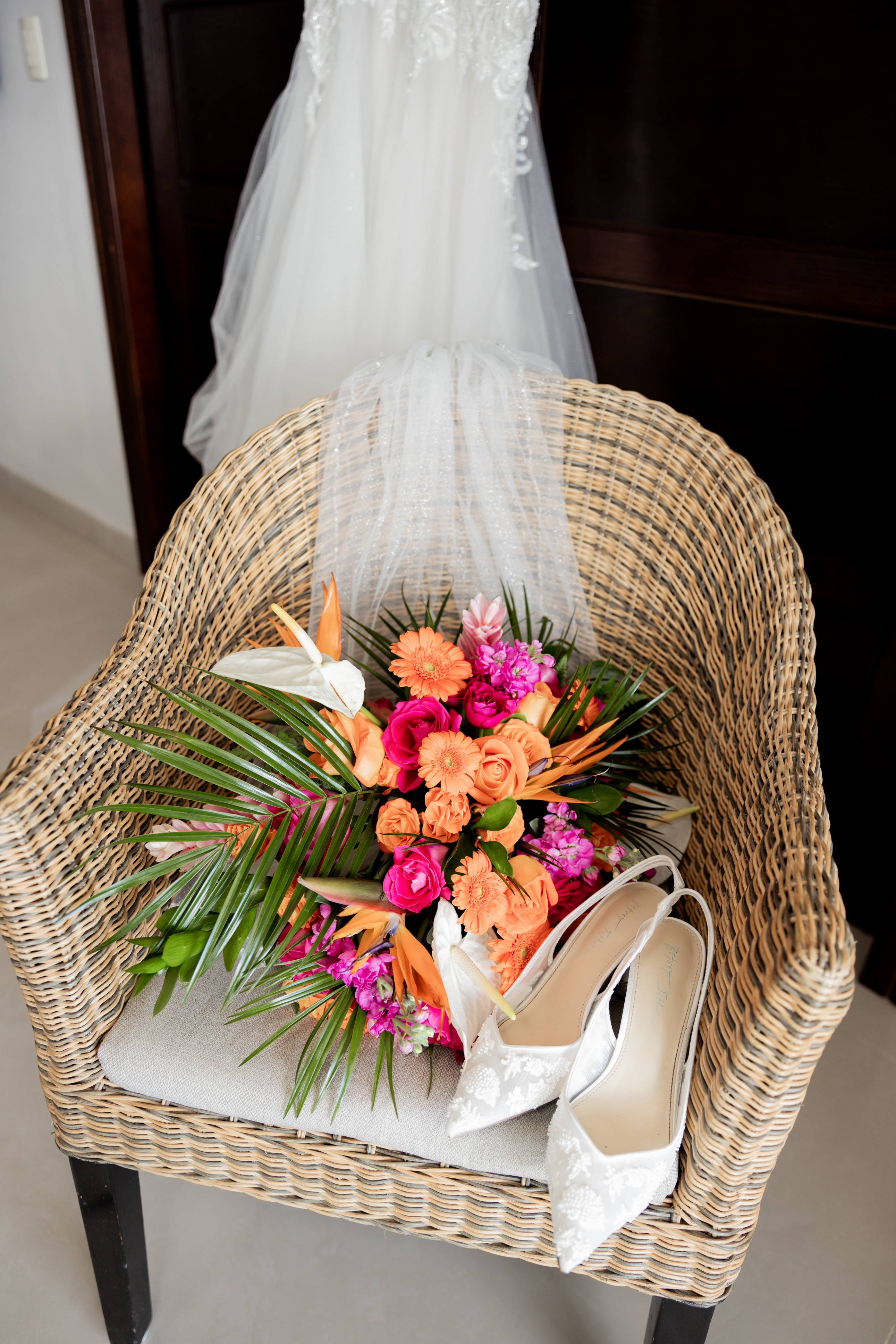 April and Javiert: Wedding bouquet, veil, and white shoes arranged with dress for a destination wedding.