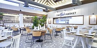 Bright, modern restaurant with empty tables, ideal for a destination wedding at Bahia Principe Grand Samana.
