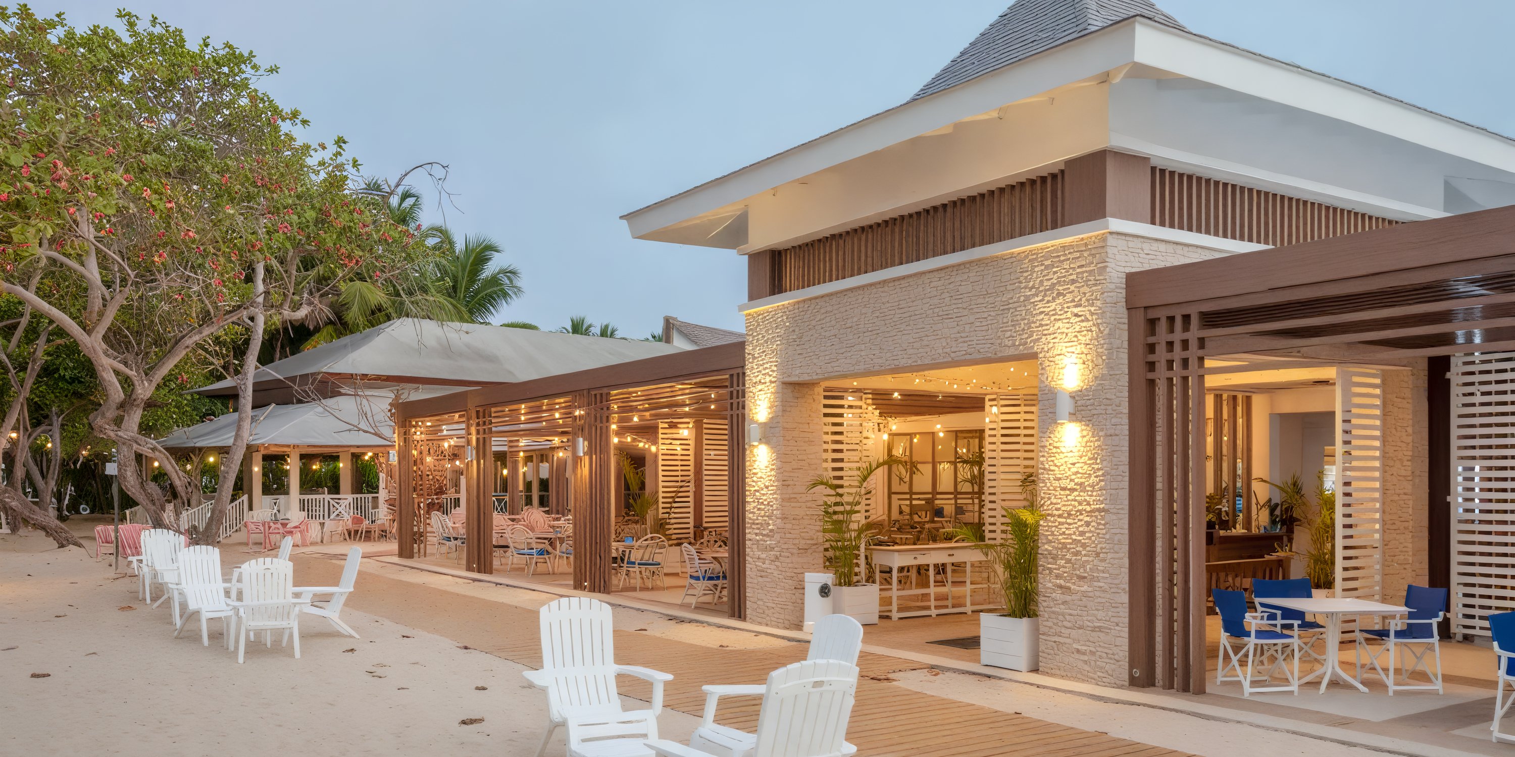 Bahia Principe Grand El Portillo: beachfront wedding dining with outdoor seating and string lights.