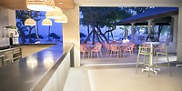 Indoor-outdoor bar with wicker chairs at Bahia Principe Grand Samana, perfect for a destination wedding.