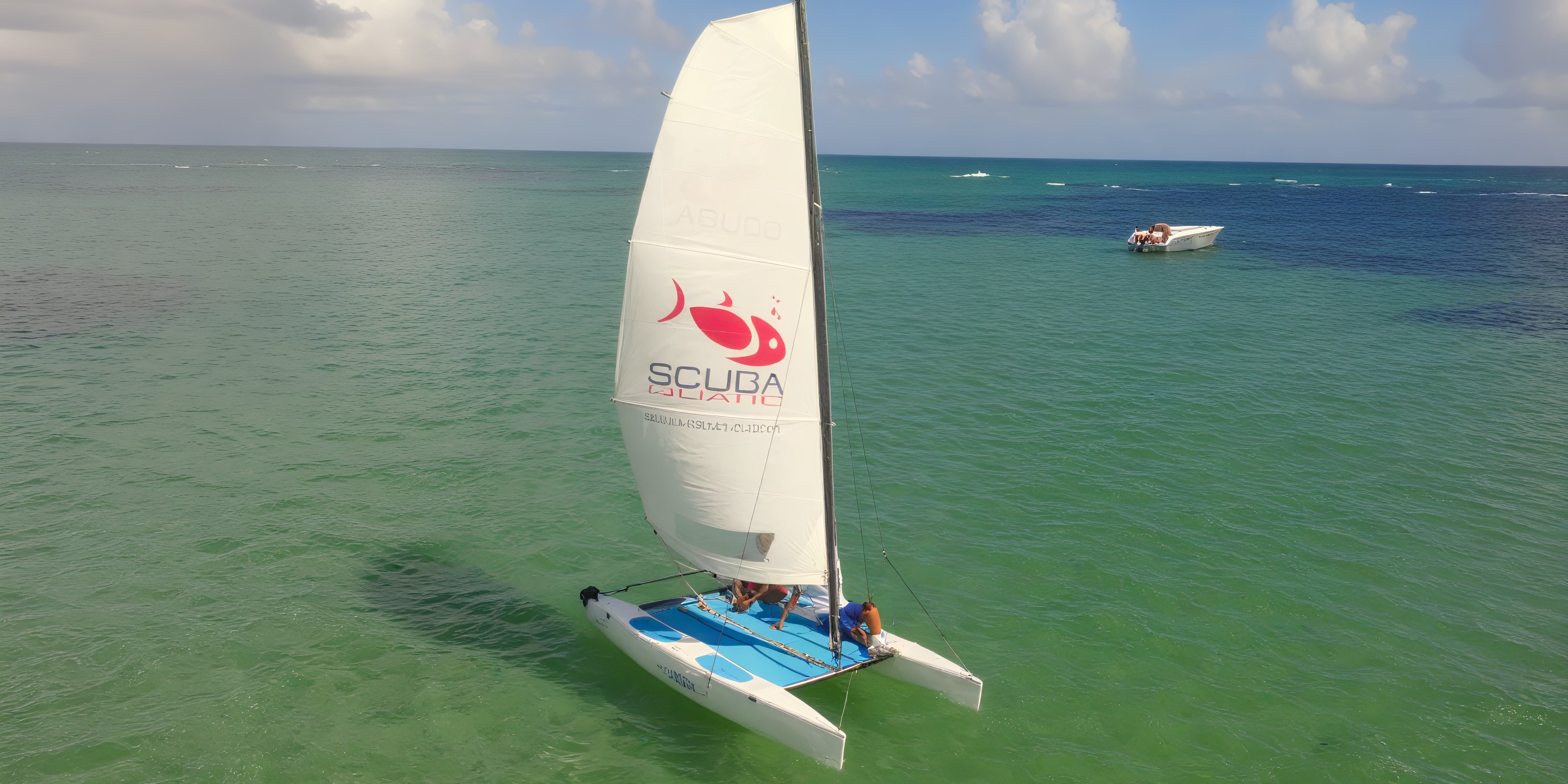 A small sailboat with "Bahia Principe Grand Samana" sails on calm ocean water, perfect for a wedding.