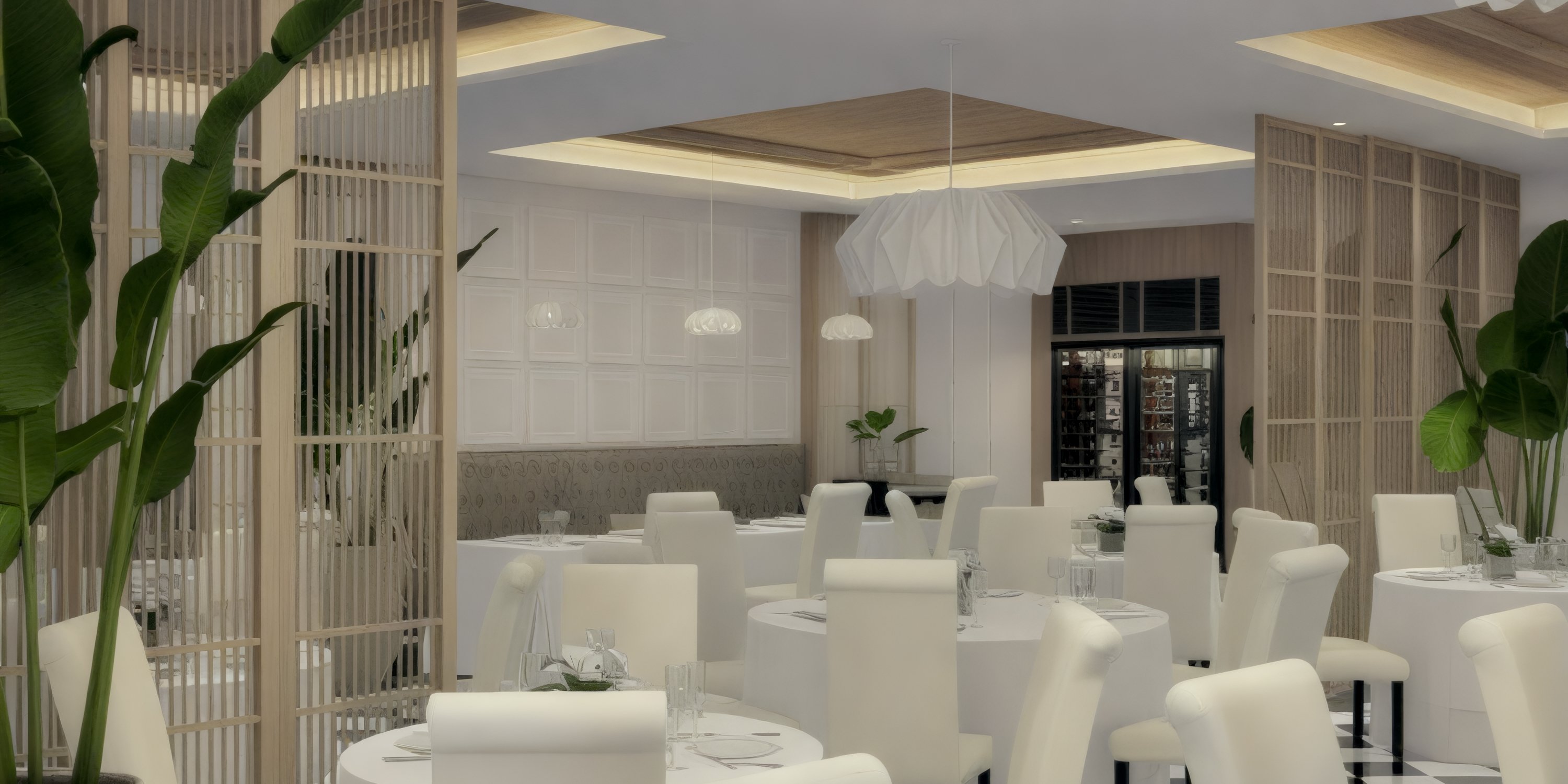 Contemporary Bahia Principe Grand El Portillo interior set for a destination wedding with white chairs, round tables, and lush plants.