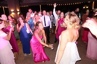 Guests mingle and dance at a lively indoor destination wedding celebration in Billi and Trevor (Copy).