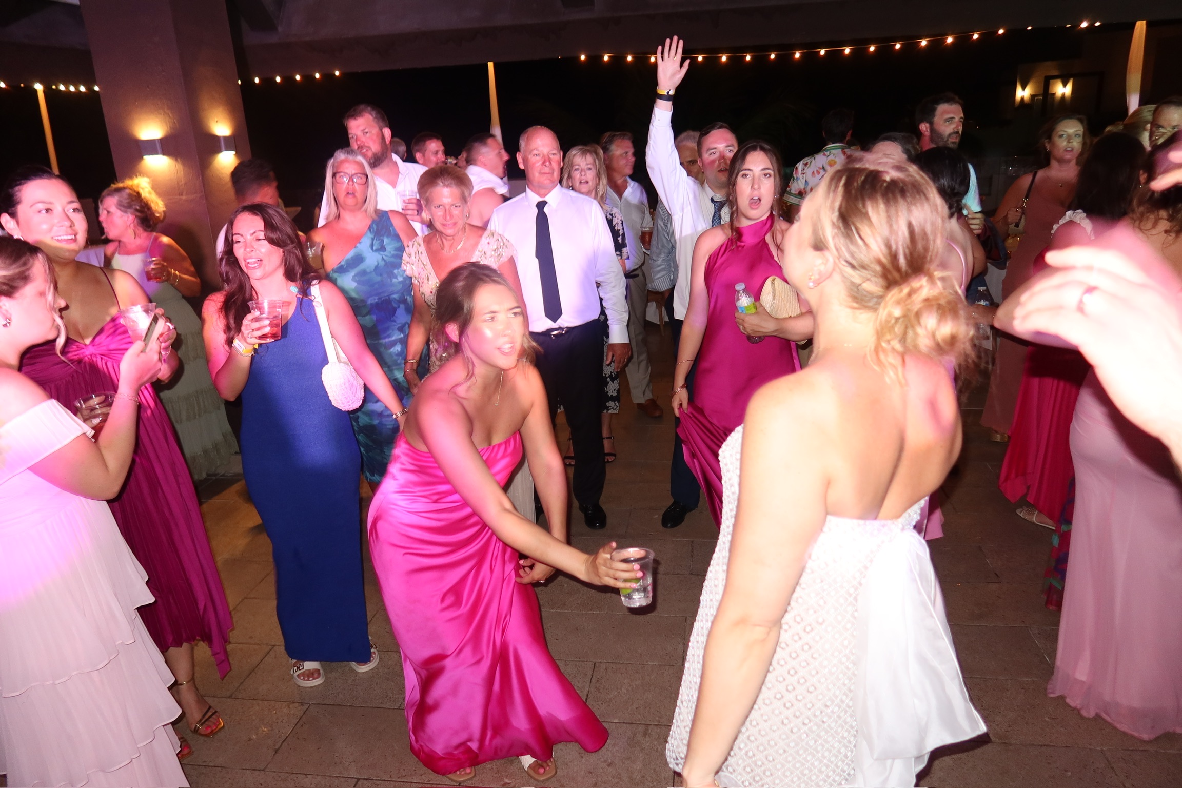 Guests mingle and dance at a lively indoor destination wedding celebration in Billi and Trevor (Copy).