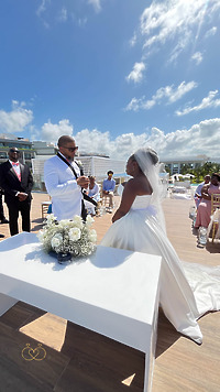 Iyana and Marcello say their vows at a sunny outdoor altar during their beautiful destination wedding.
