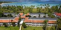 Aerial view of Wyndham Alltra Punta Cana, an ideal destination wedding spot with red roofs, palms, ocean.
