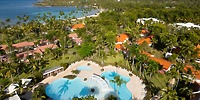 Aerial view of Wyndham Alltra Punta Cana, an ideal destination wedding spot with pools, palms, and coast.
