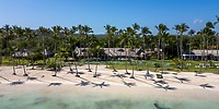 Wyndham Alltra Punta Cana: ideal destination wedding spot with sandy beach, palm trees, and blue sky.