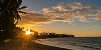 Sunset at Wyndham Alltra Punta Cana, perfect for a destination wedding with palms, beach, and waves.