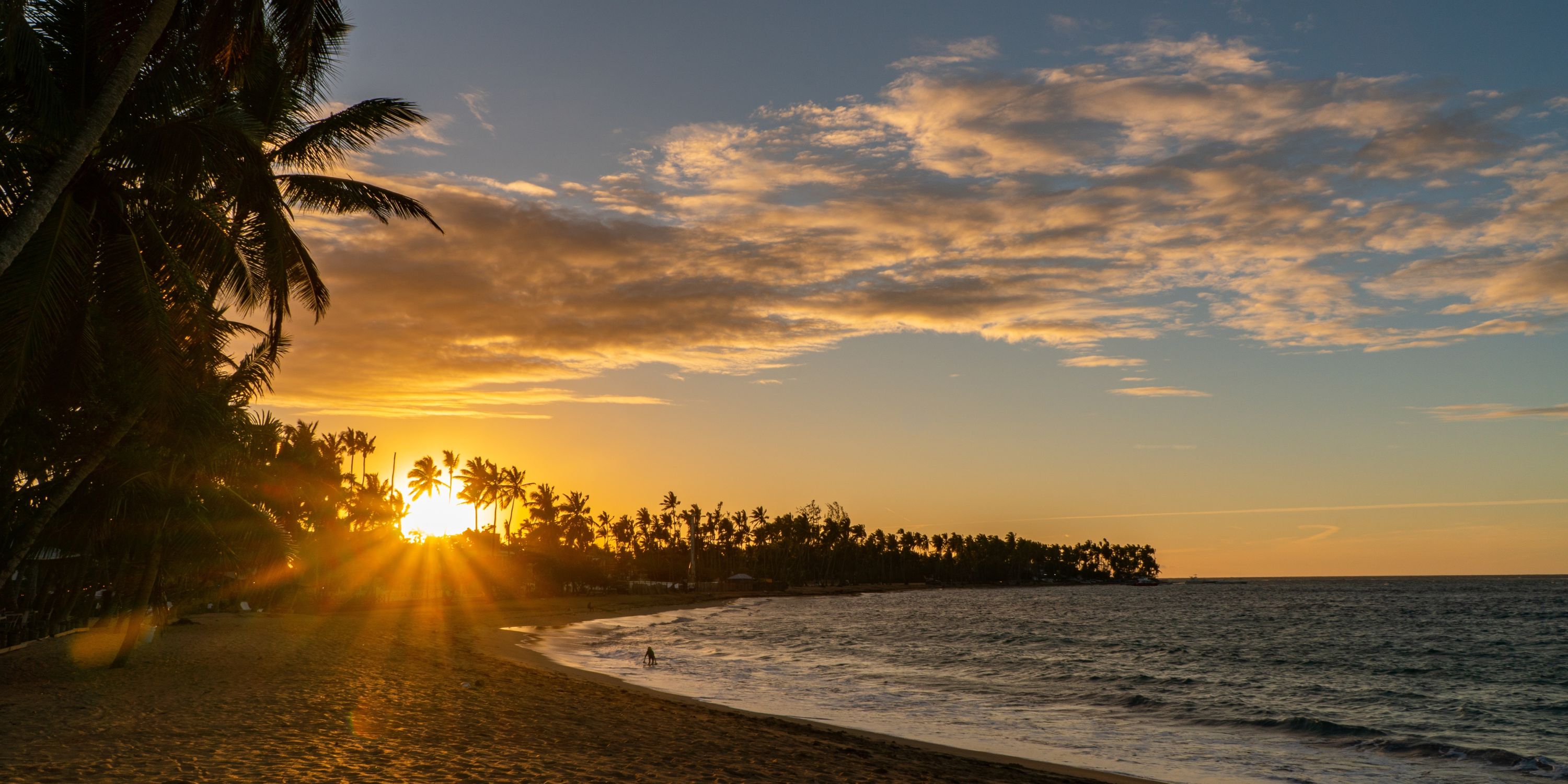 Sunset at Wyndham Alltra Punta Cana, perfect for a destination wedding with palms, beach, and waves.