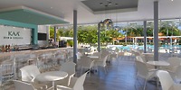 Modern open-air bar and lounge at Wyndham Alltra Punta Cana, ideal for destination wedding views of pool and gardens.