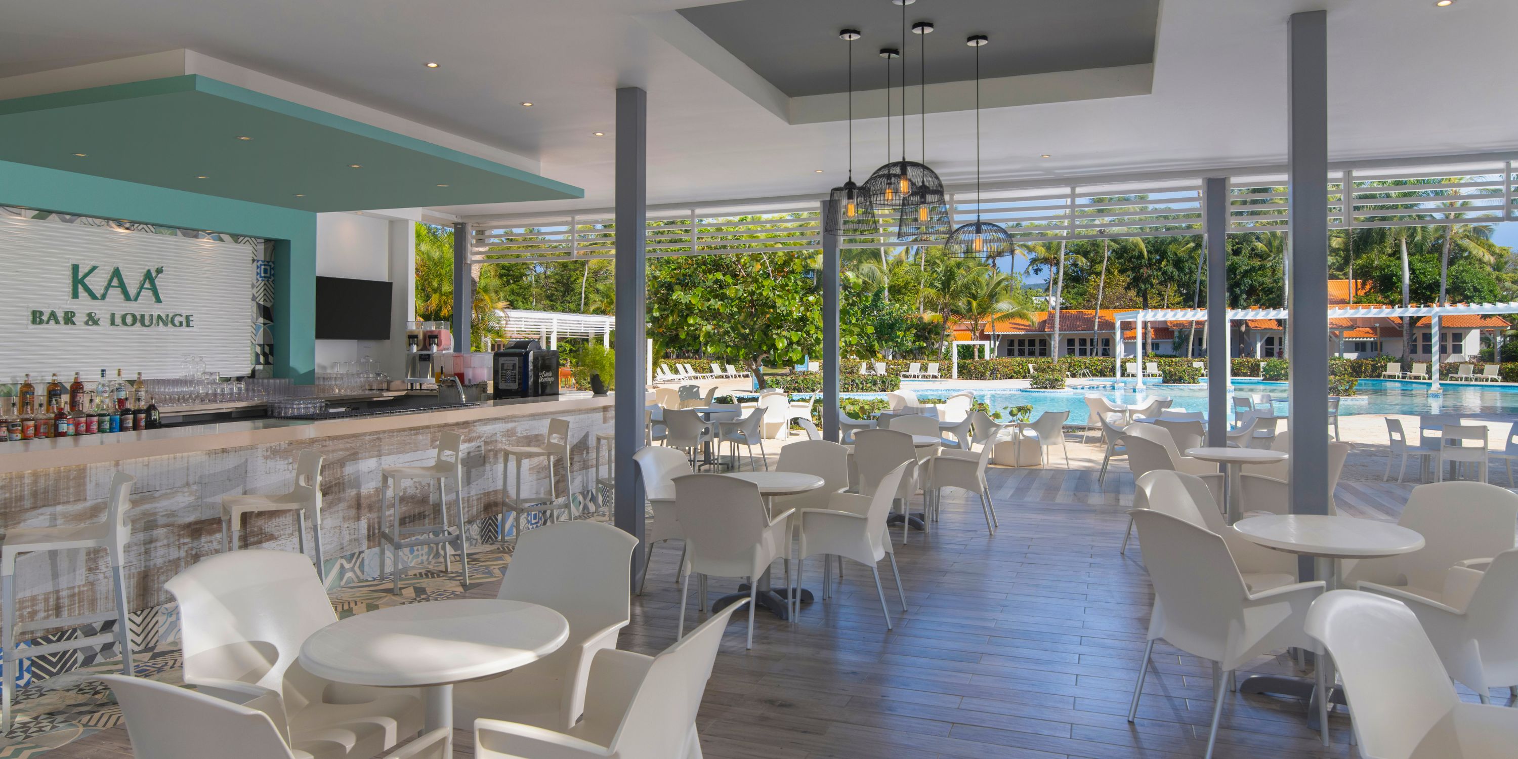 Modern open-air bar and lounge at Wyndham Alltra Punta Cana, ideal for destination wedding views of pool and gardens.