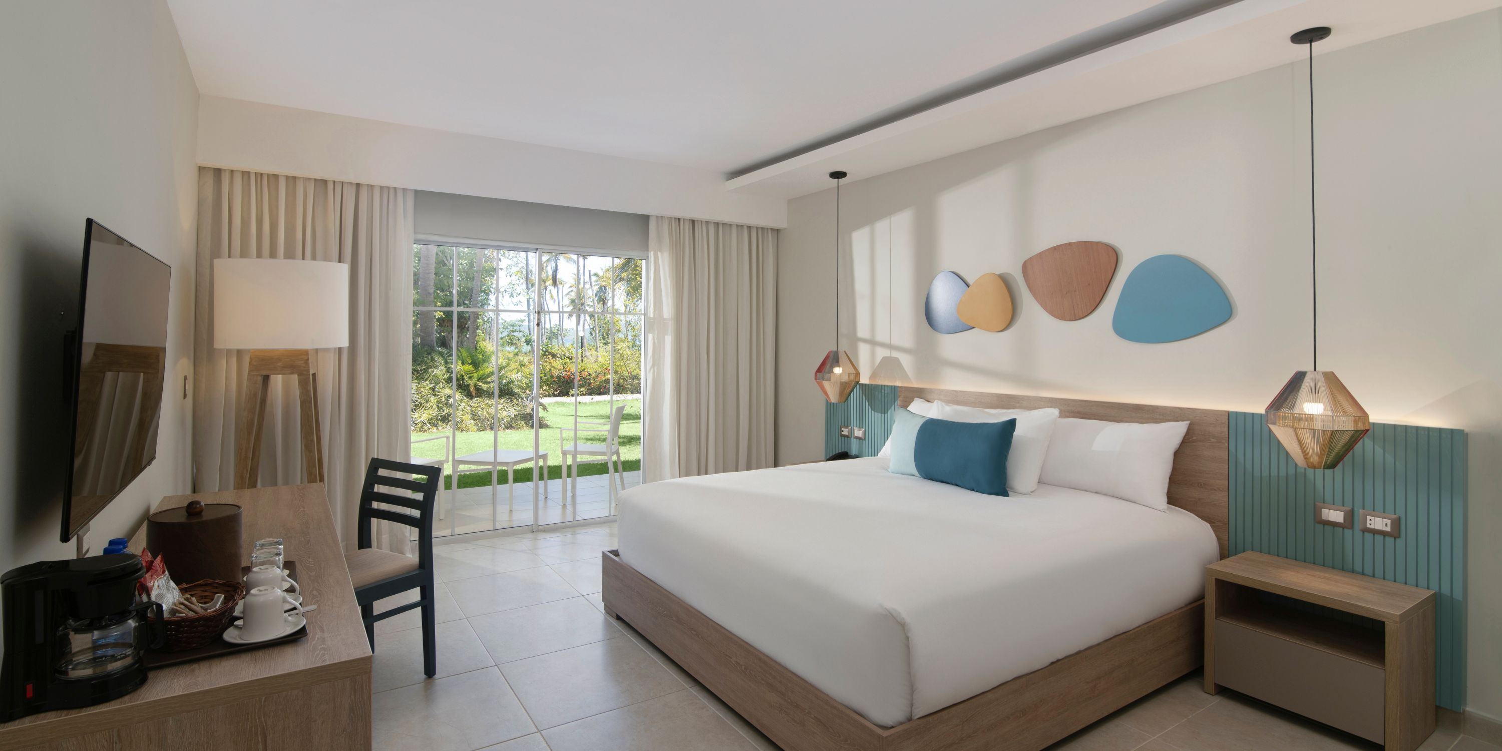 Modern room at Wyndham Alltra Punta Cana, perfect for a destination wedding, features king bed and garden view.