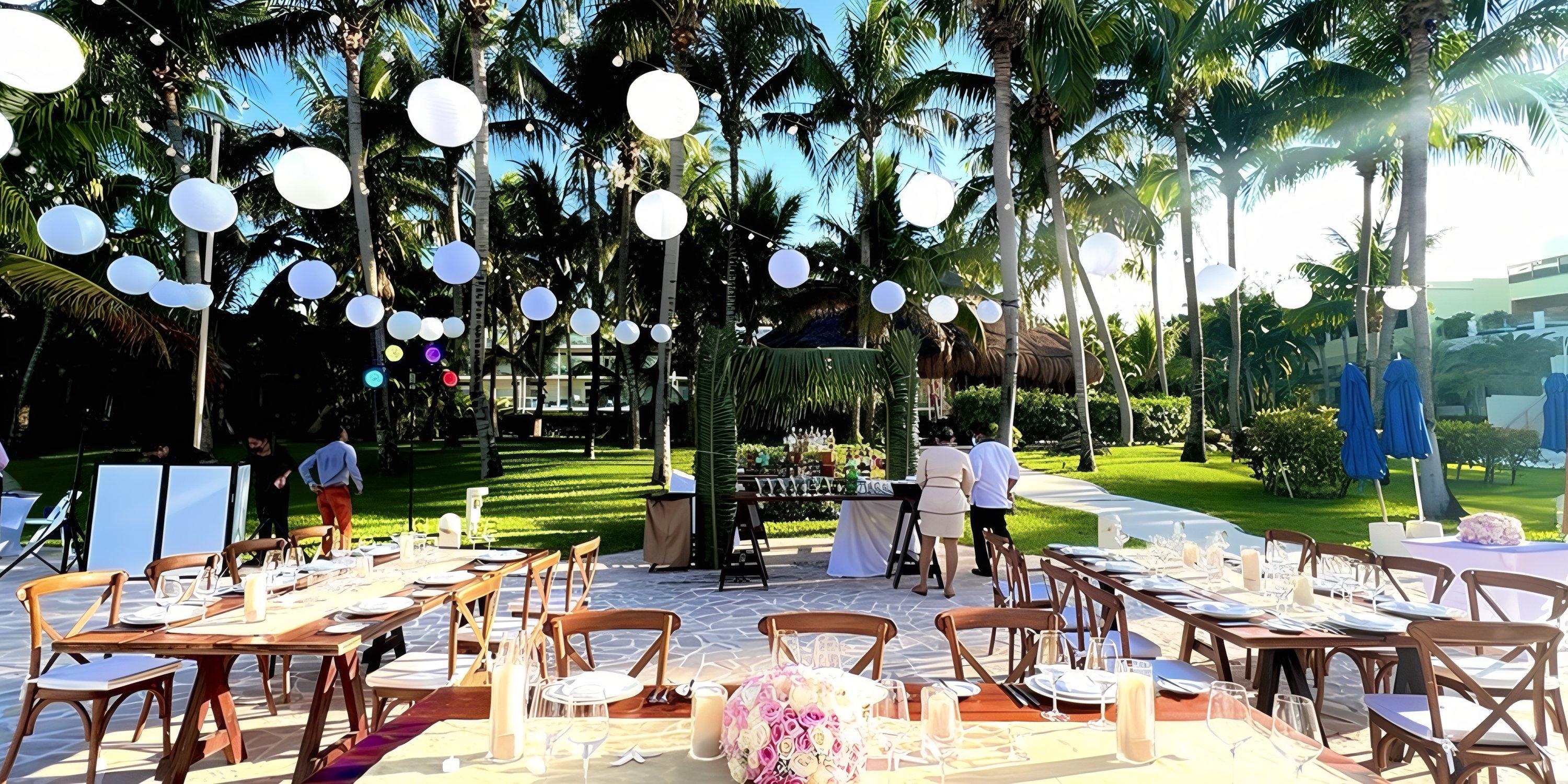 Destination wedding setup at Iberostar Selection Riviera Cancun with decorated tables, lights, and palms.