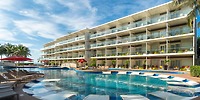 Modern beachfront Iberostar Selection Riviera Cancun, perfect for a destination wedding, with balconies and a large pool.