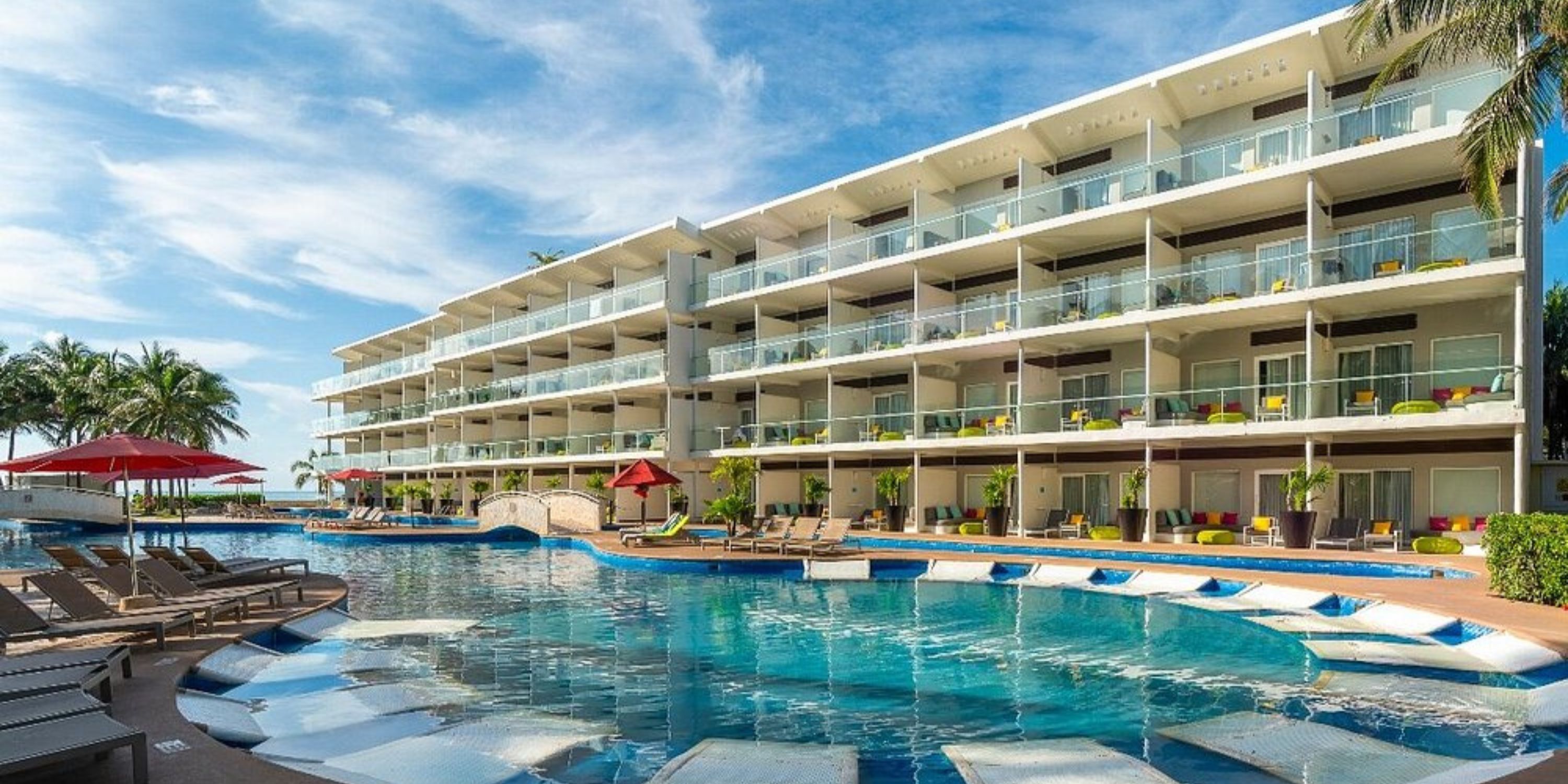 Modern beachfront Iberostar Selection Riviera Cancun, perfect for a destination wedding, with balconies and a large pool.
