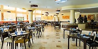 Chic restaurant at Iberostar Selection Riviera Cancun set for a wedding, bathed in natural light.